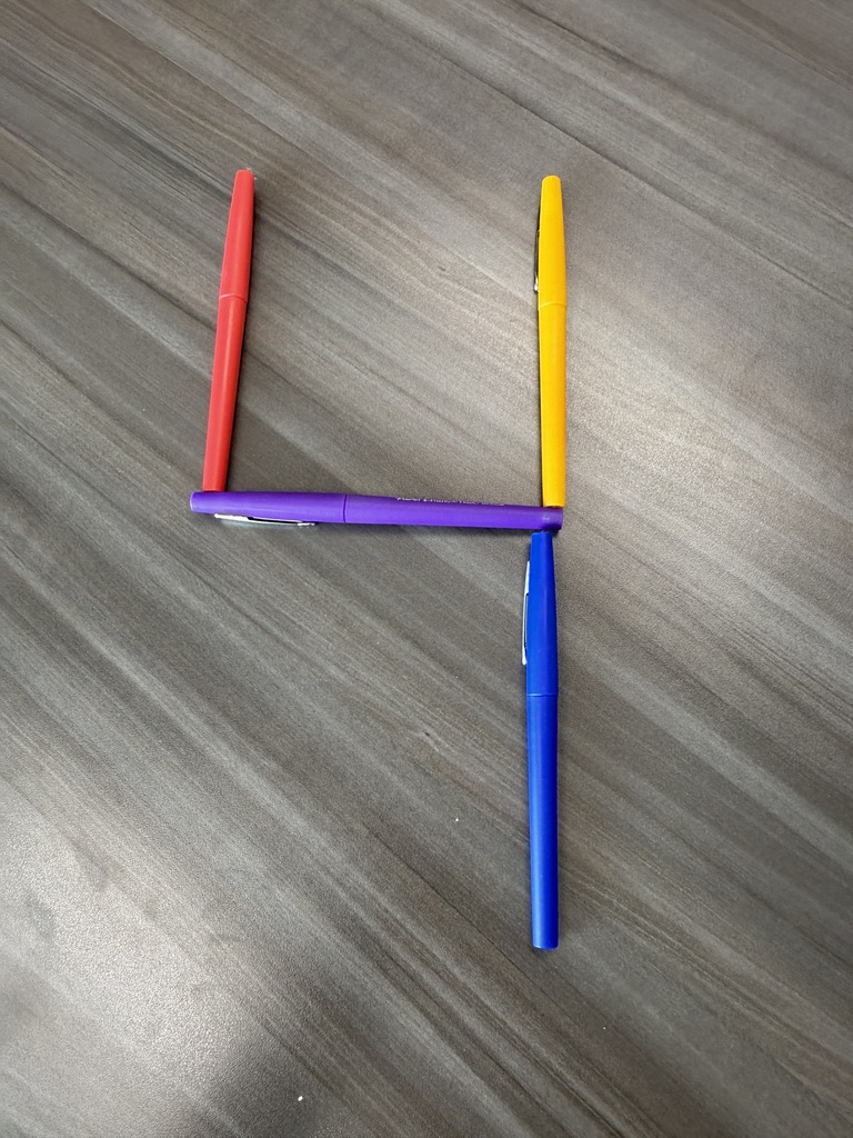 the number 4 made out of colored pens