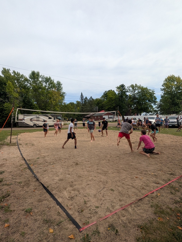 people playing sand volleyball