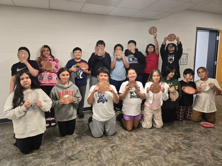 group of students holding art work