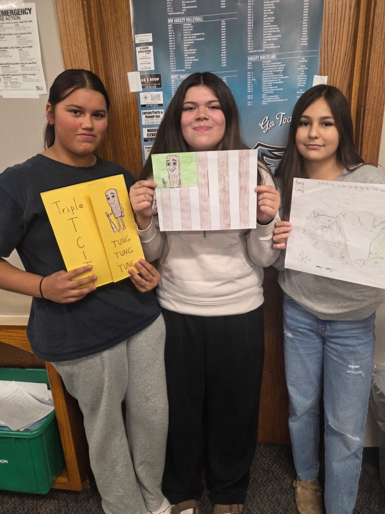 three students standing with your Nation Creation project