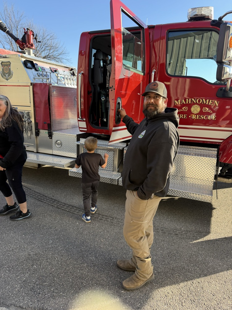people standing by the fire truck