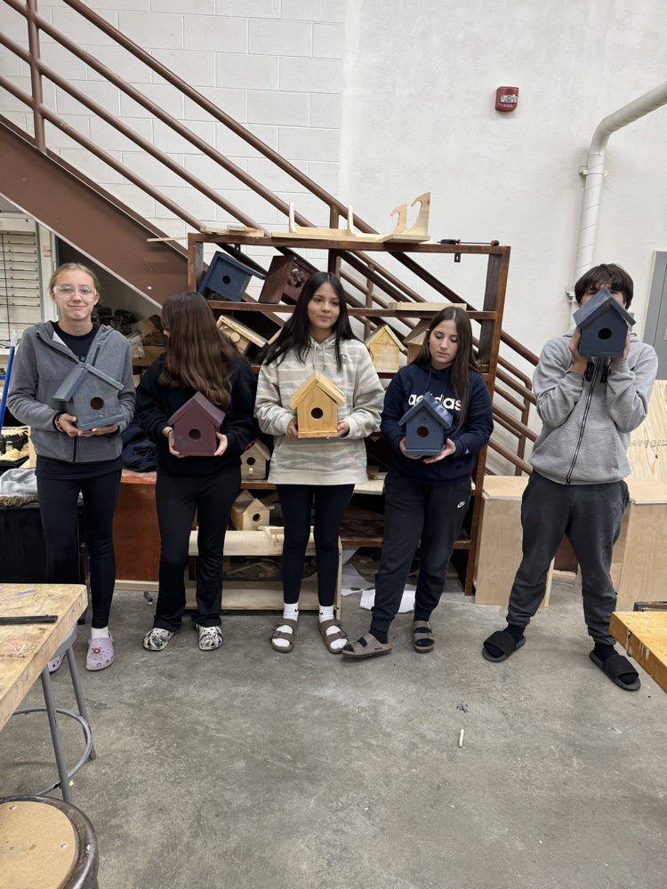students holding birdhouses