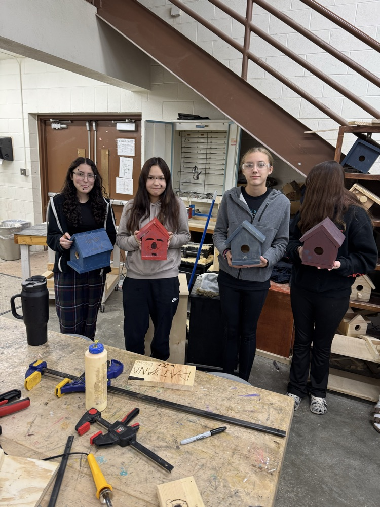 students holding bird houses