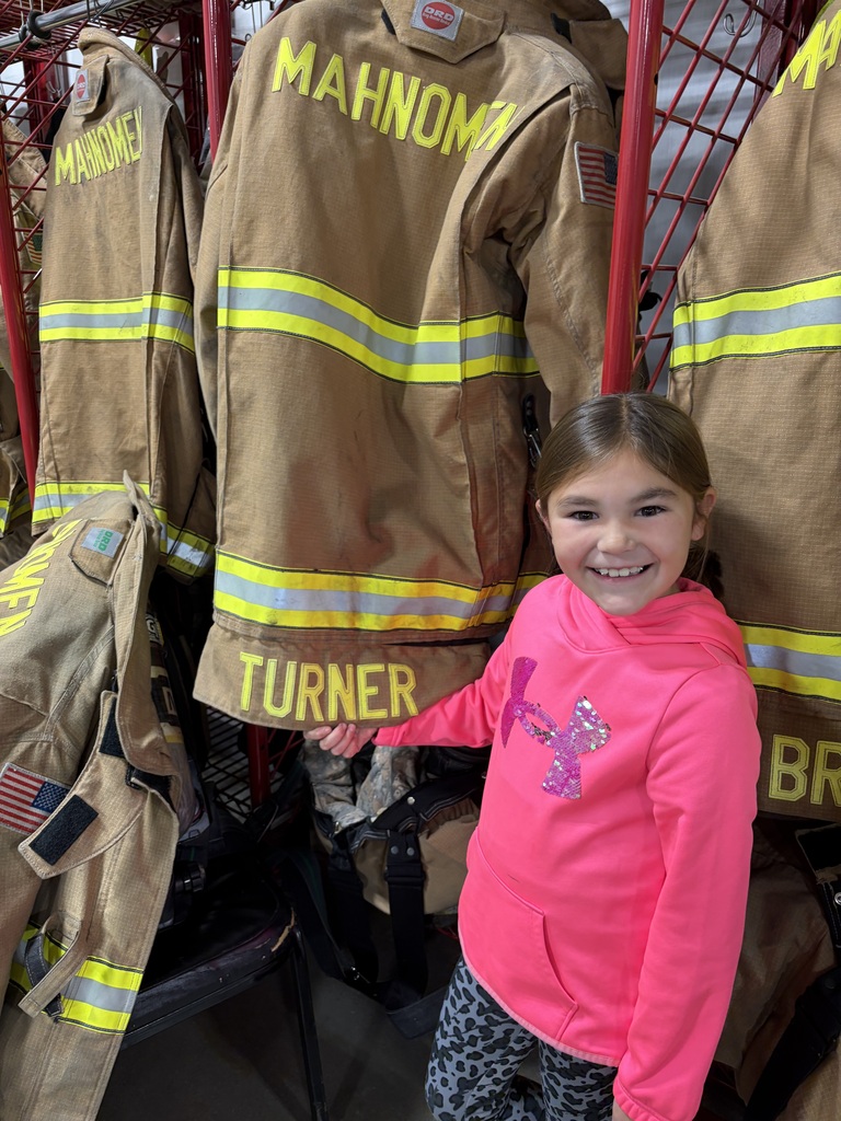 Student standing next to fire turnout gear