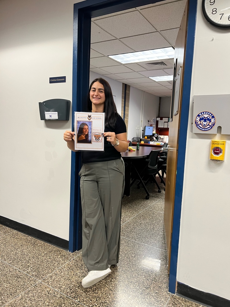 Assistant Principal Cristina Giansante holding her senior year photo as part of a new initiative