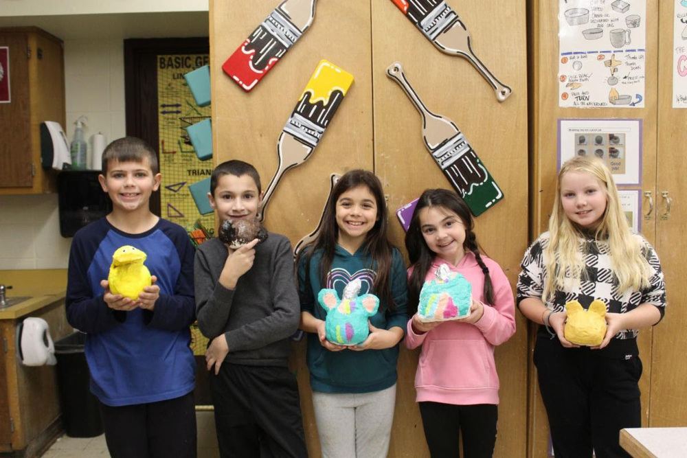 Students showing off their artwork