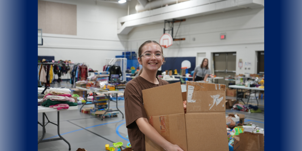 student holding box at community garage sale