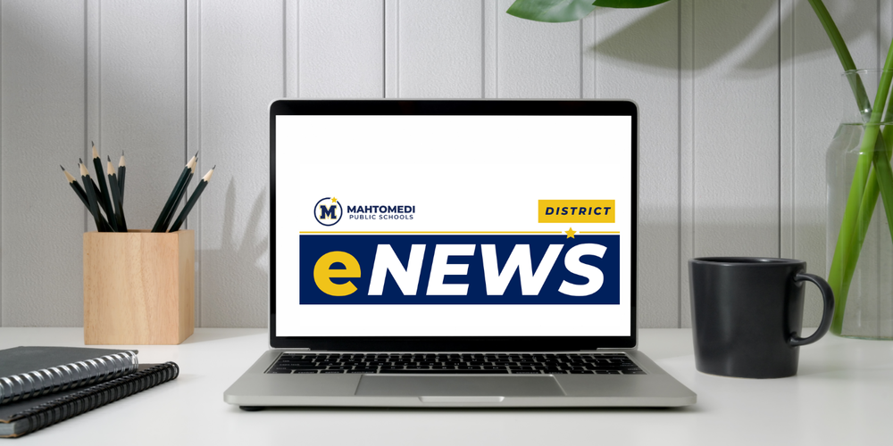 Laptop on a desk next to pencils