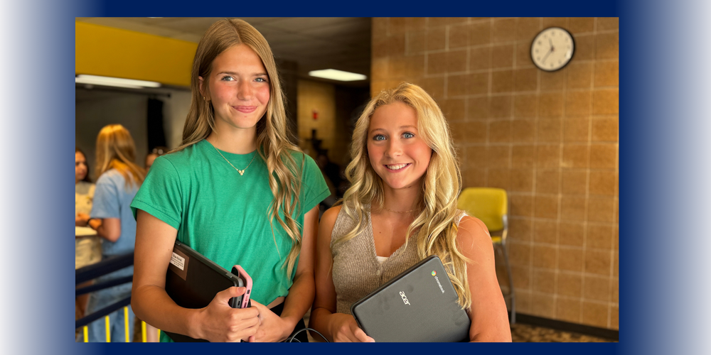 students holding chromebooks