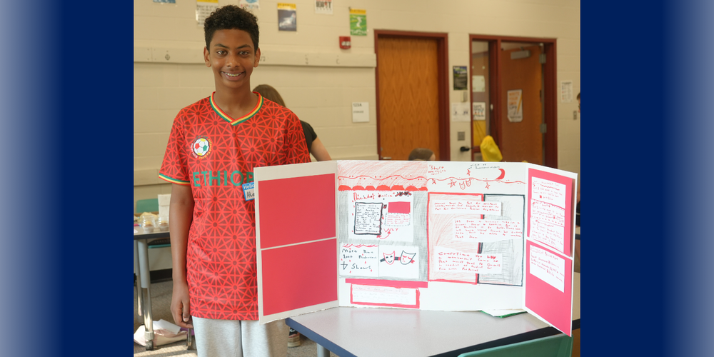 Student standing next to presentation 
