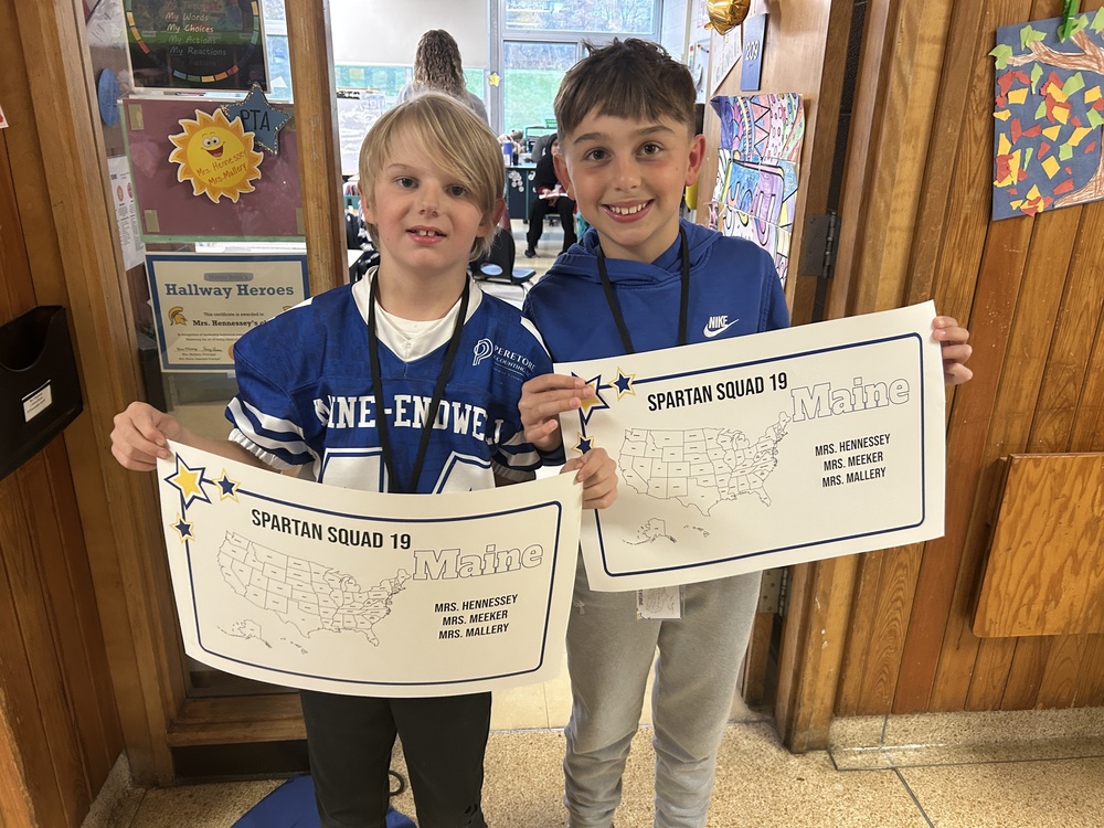 kids smiling holding maps