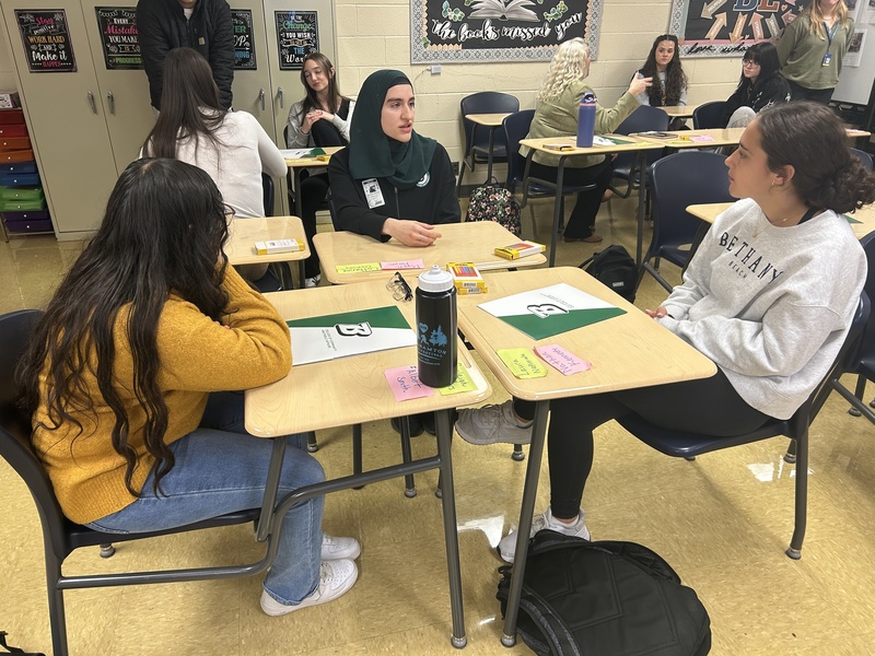 students talking at tables