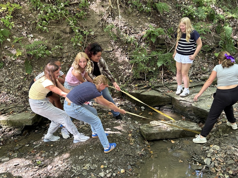 kids pulling a rock