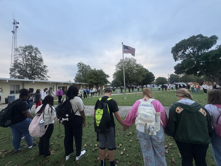 student standing around a pole praying