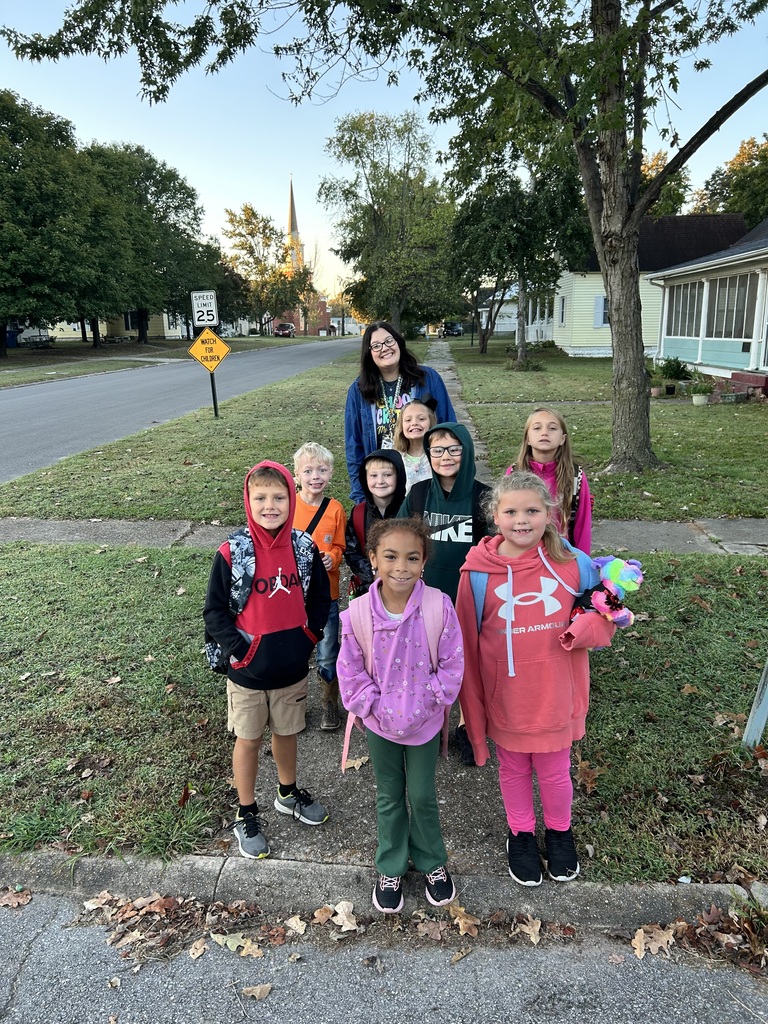 kids smiling as they walk to school