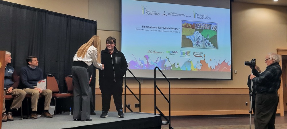 Photo of Bennett Babbie, sixth grader at Davis Elementary, receiving silver for his artwork.