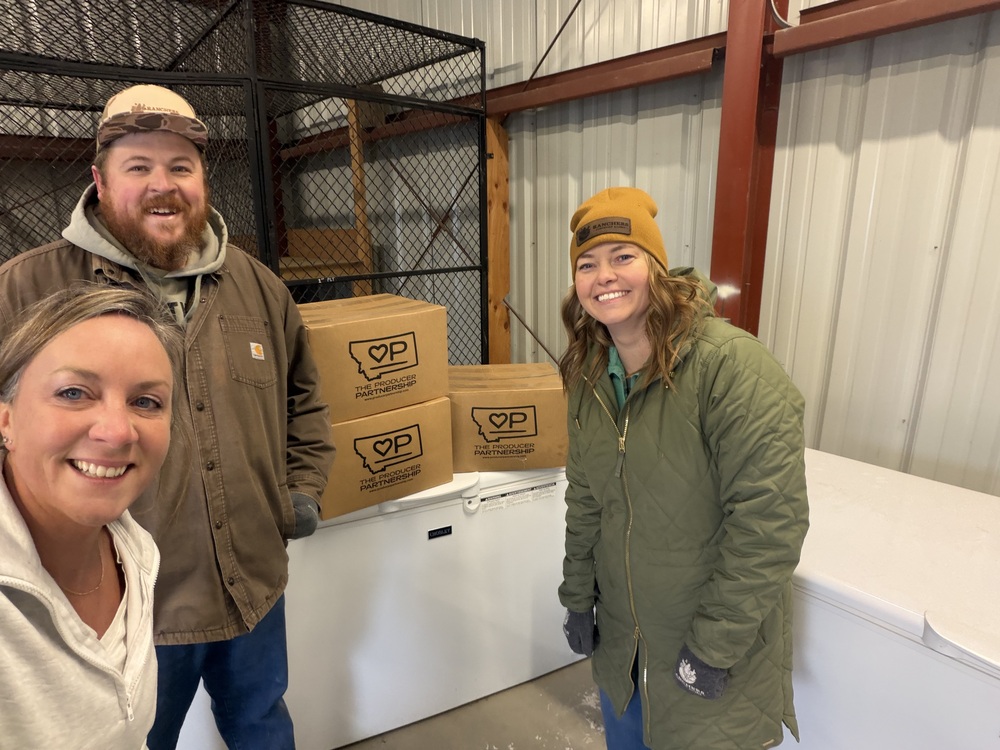 RSA Employees Mary Oxarart, Martin Townsend, and Angel DeVries stay warm while they pack up beef