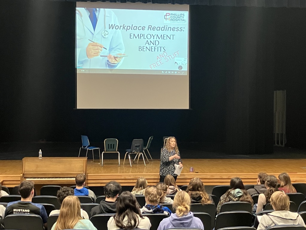 teacher presenting to an auditorium of students