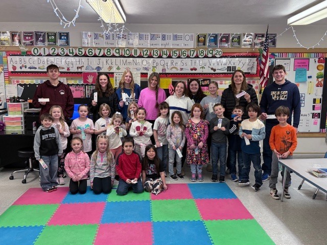 NHS members read to Mrs. Ost and Mrs. Tuss's kindergarten students. 