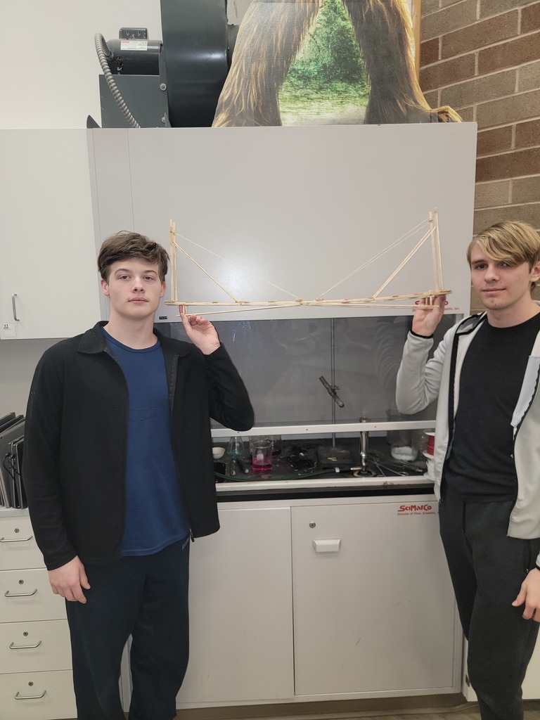 Two males students display their bridge. Group #3