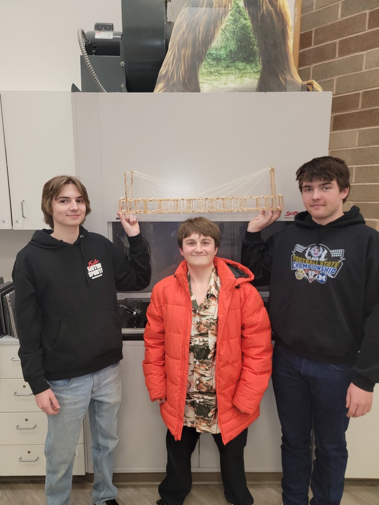 Three students pose with their bridge. Group #1