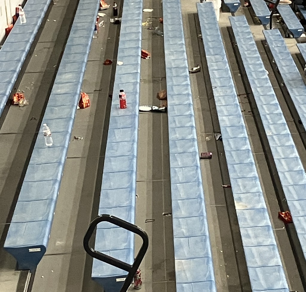 gym bleachers covered in trash. 