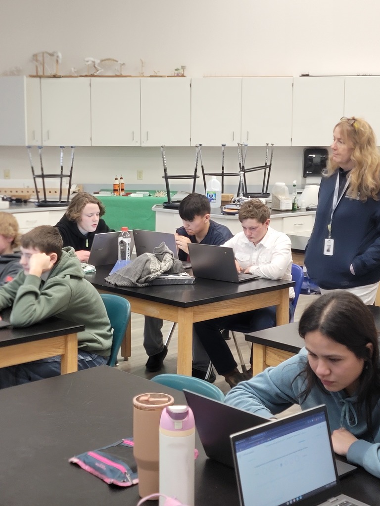 Teacher monitoring students taking a personality inventory.