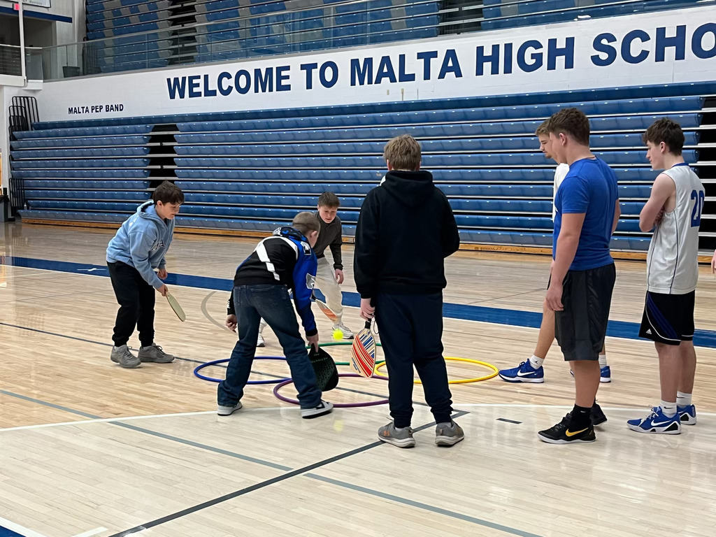 Malta students playing a game of 4-square paddleball.