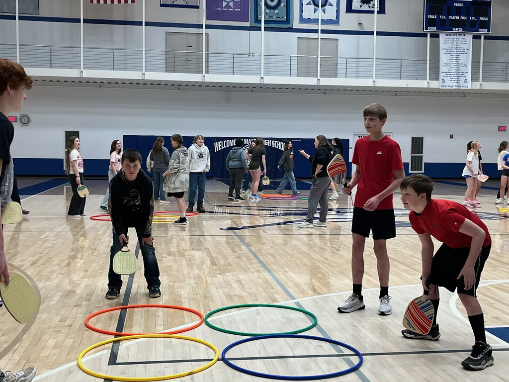 Malta students playing a game of 4-square paddleball.