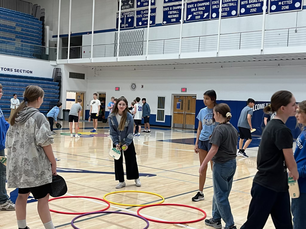 Malta students playing a game of 4-square paddleball.