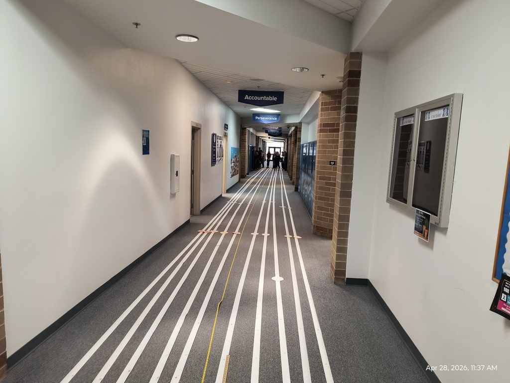 100 ft long strips of receipt tape with images of the planets on it, at the end is a crowd of students.