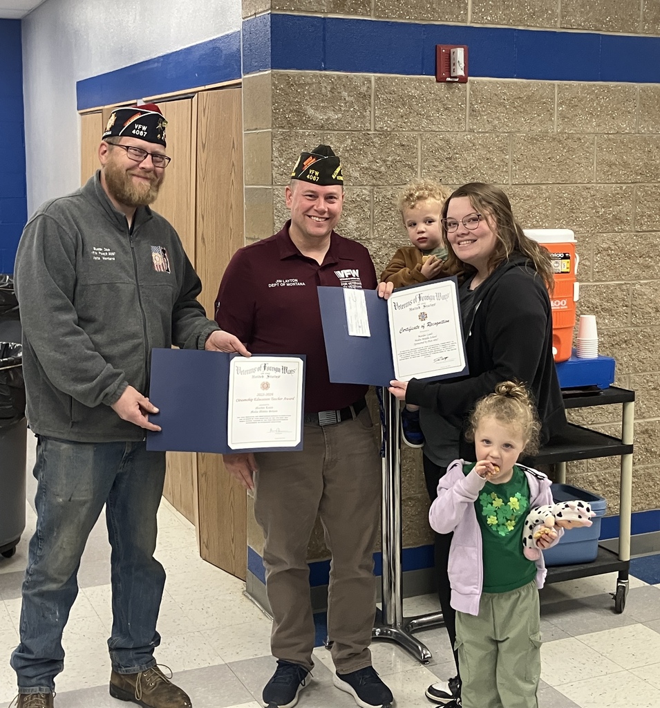 people holding certificates smiling. 