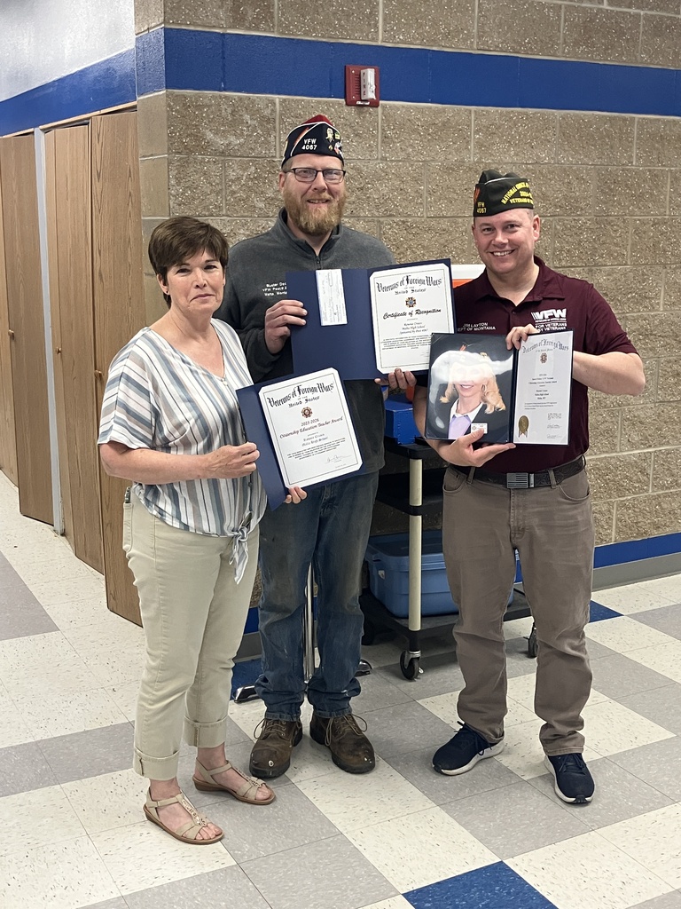 three people holding certificates