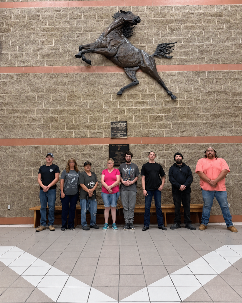 photo of custodial and maintenance staff in front of the mustang
