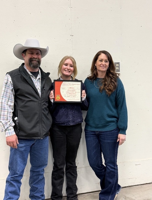Student receiving award with her parents
