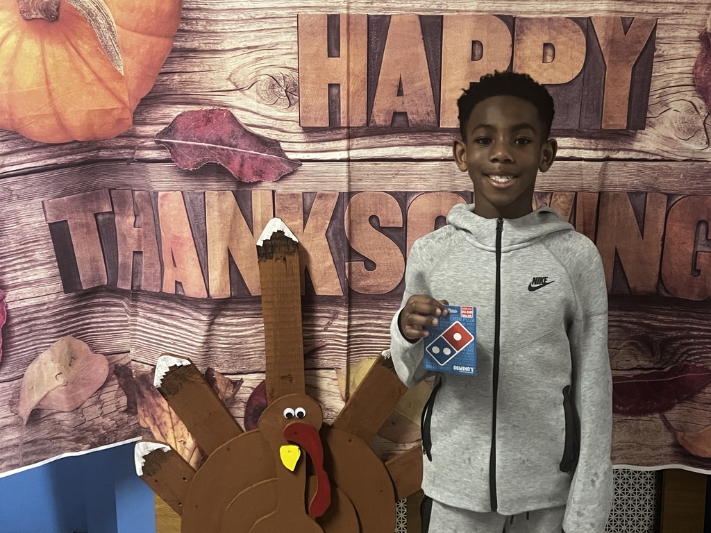 student with raffle prize of domino's gift card