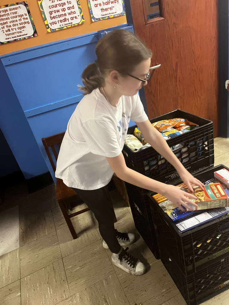 student packing boxes of food for donation