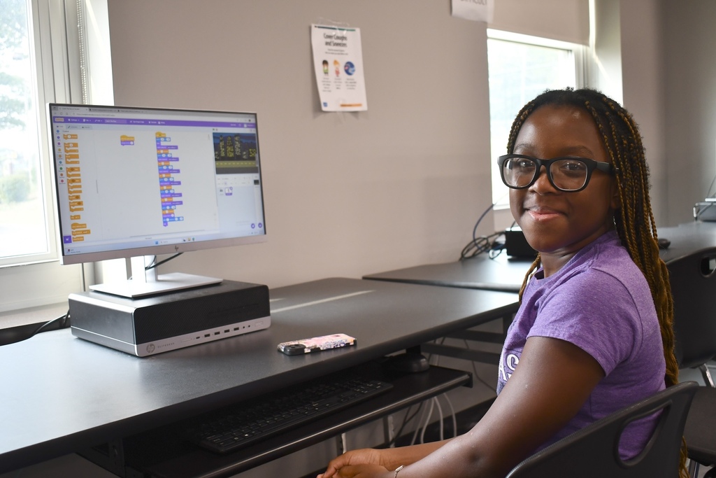 Student with a computer learning coding