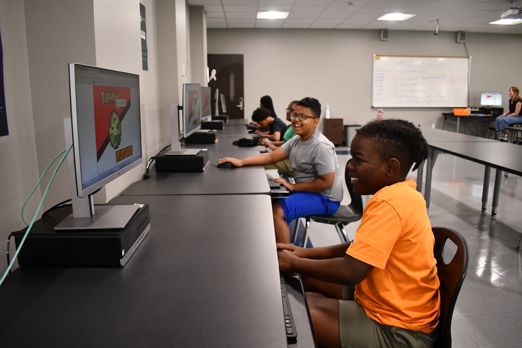 Students with computers learning coding