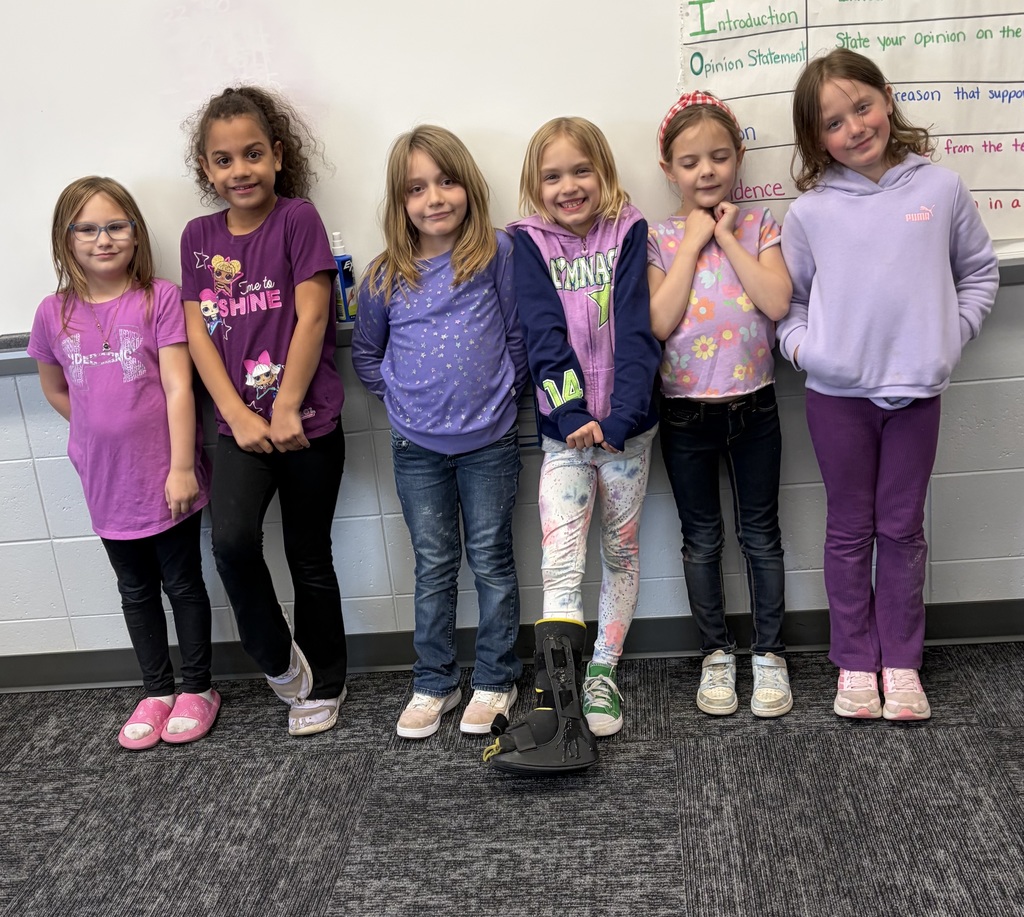 2nd grade students wearing purple in the classroom