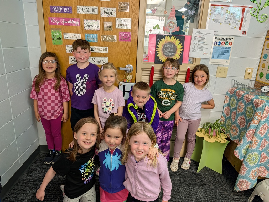 Kindergarten students wearing purple for purple day in the classroom