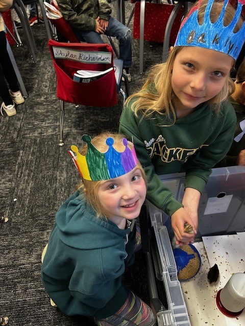 Kindergarten and 3rd grade buddies looking at the quail chicks in Mrs. Stormoens classroom