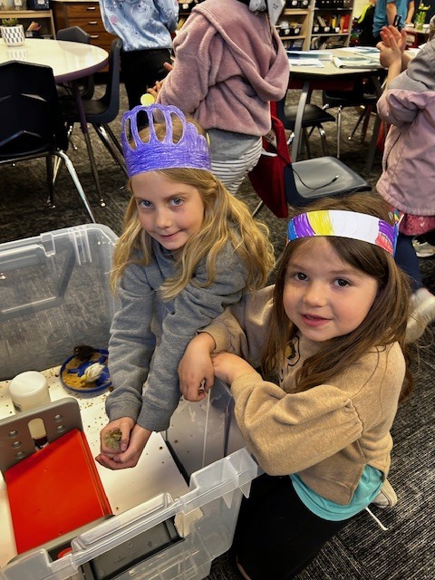 Kindergarten and 3rd grade buddies looking at the quail chicks in Mrs. Stormoens classroom