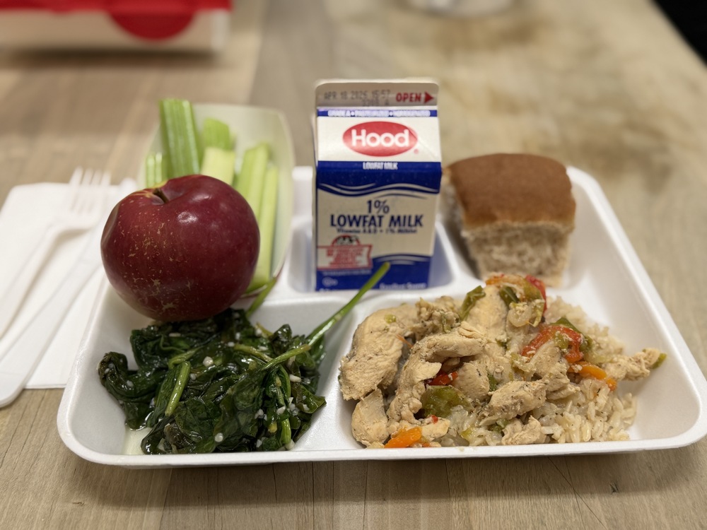 Lunch at Memorial High School showing chicken, spinach, apple, roll and milk