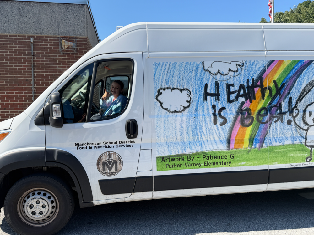 Parker Varney student in the van she designed the wrapping for. it says Healthy is Best