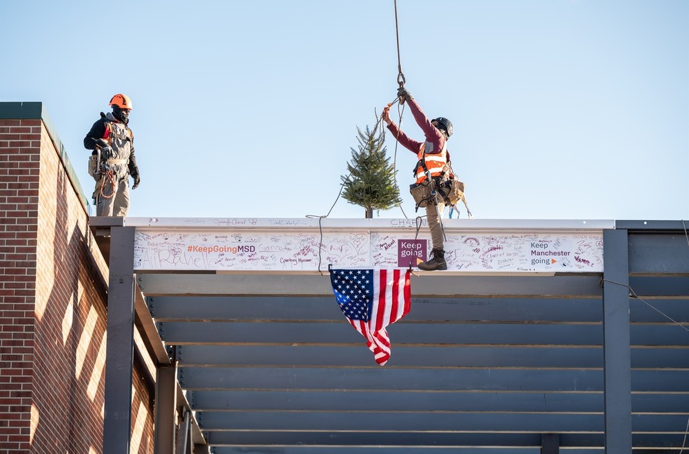 beam being raised into place at mclaughlin beam raising ceremony