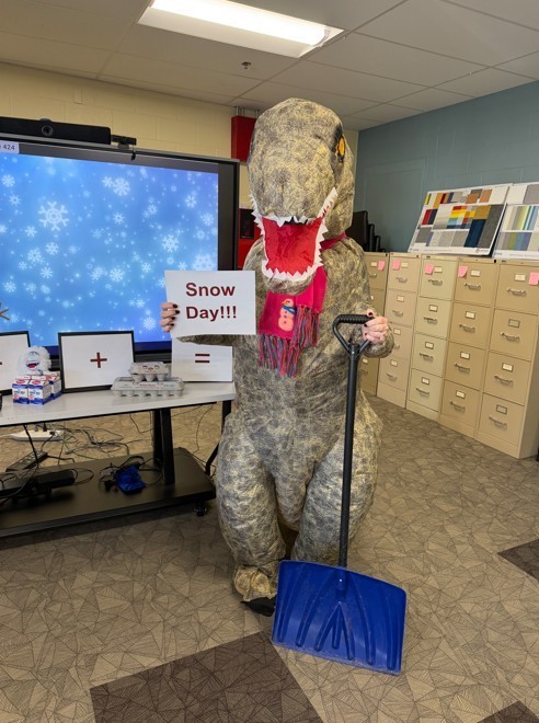 Dinosaur holding snow day sign