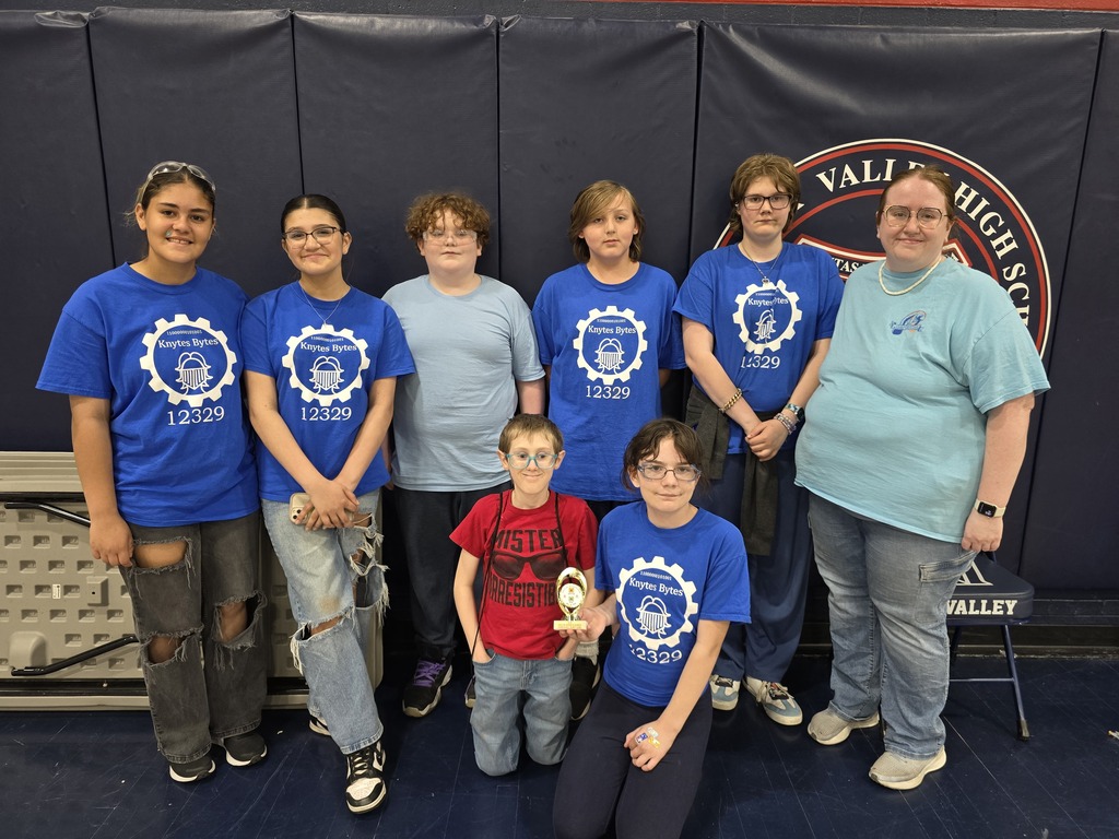 Robotics Team in their blue Knytes Bytes shirts holding trophy