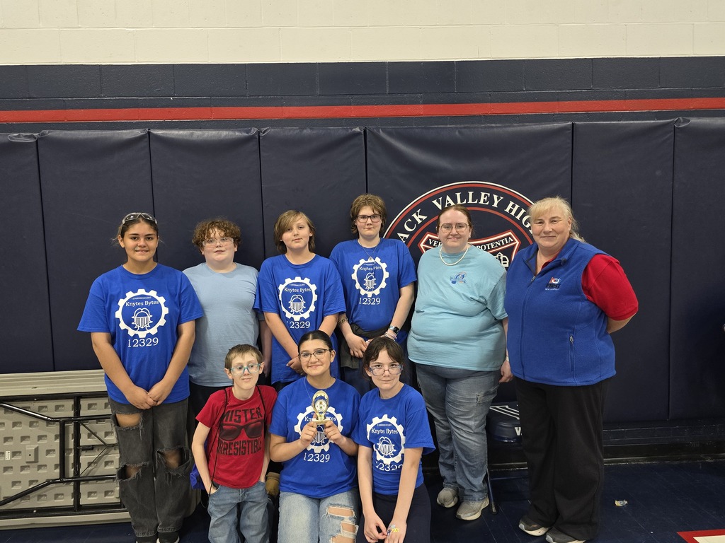 Robotics Team in their blue Knytes Bytes shirts holing trophy
