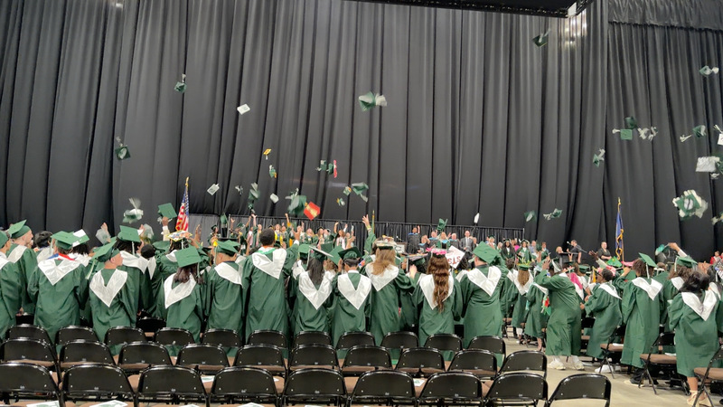 Central students throwing caps into the air